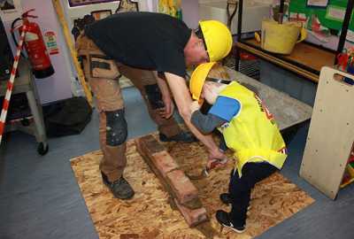 nursery school activities for children, child laying brick
