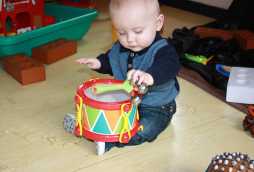 individual childcare Nottingham, toddler playing with toy drum