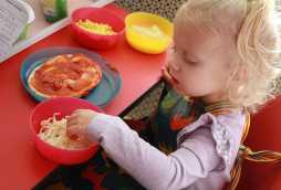 day nursery facilities, child making a pizza